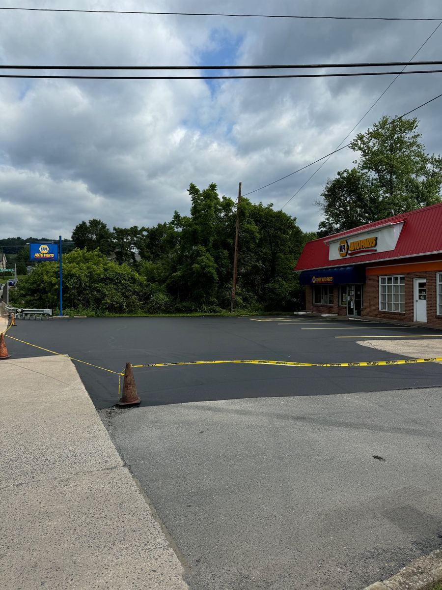 After asphalt sealcoating – fresh black commercial parking lot, Central PA
