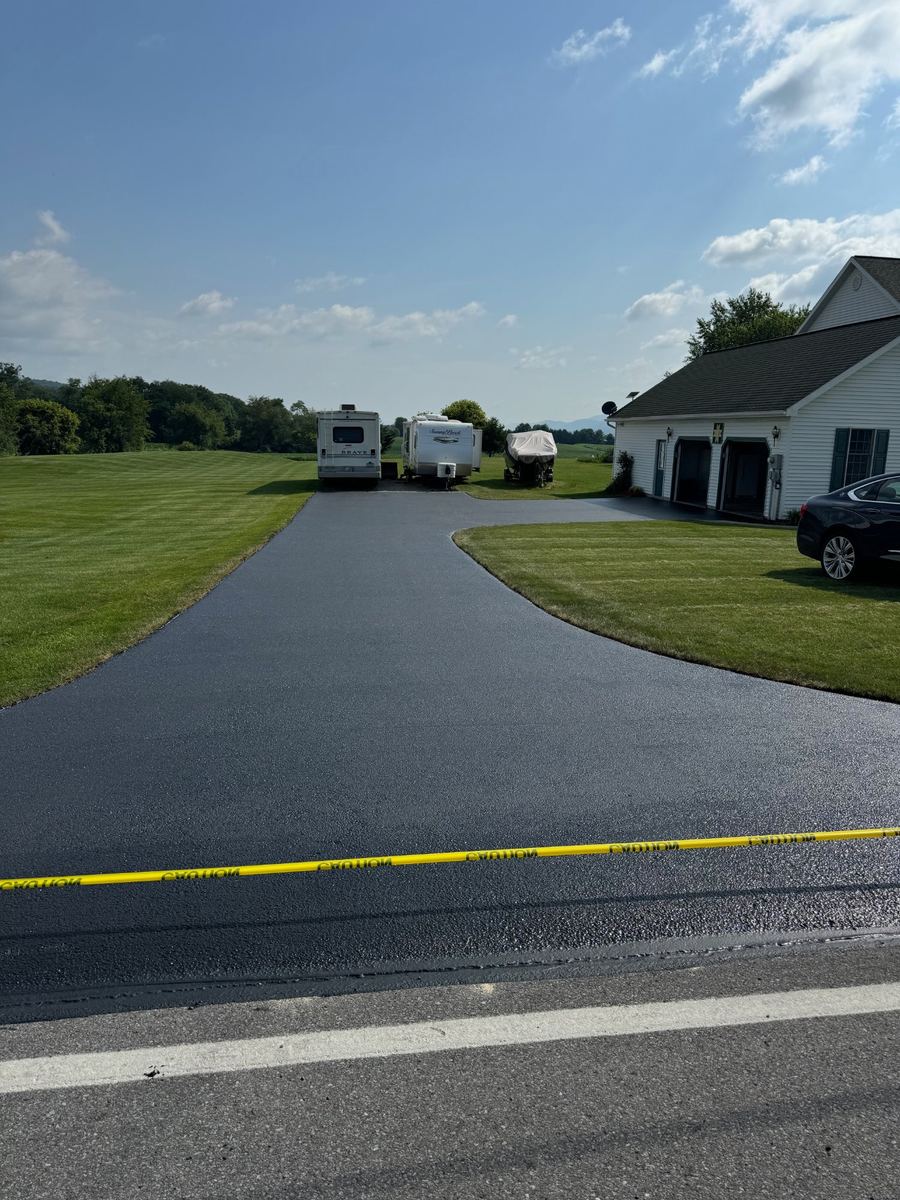 After sealcoating – freshly sealed curved residential driveway in Clinton County PA