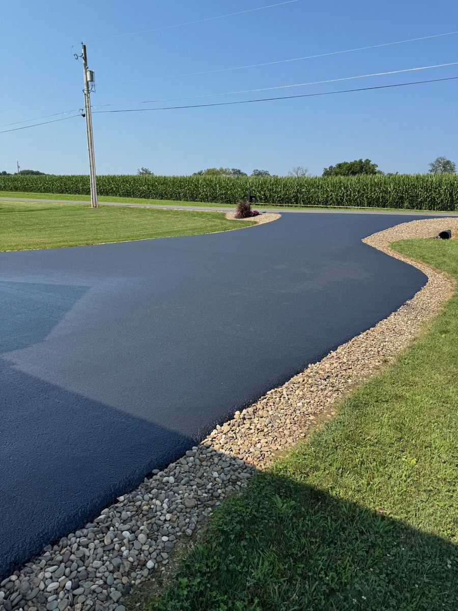 Sealed driveway with stone border edging – sealcoating work by Vinny Allison