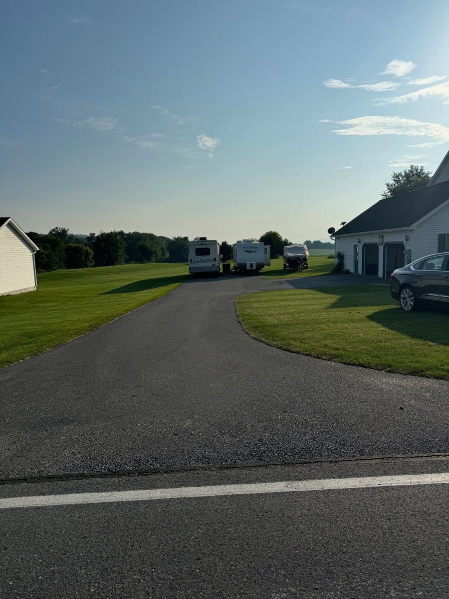 Before sealcoating – faded curved residential driveway in Clinton County PA