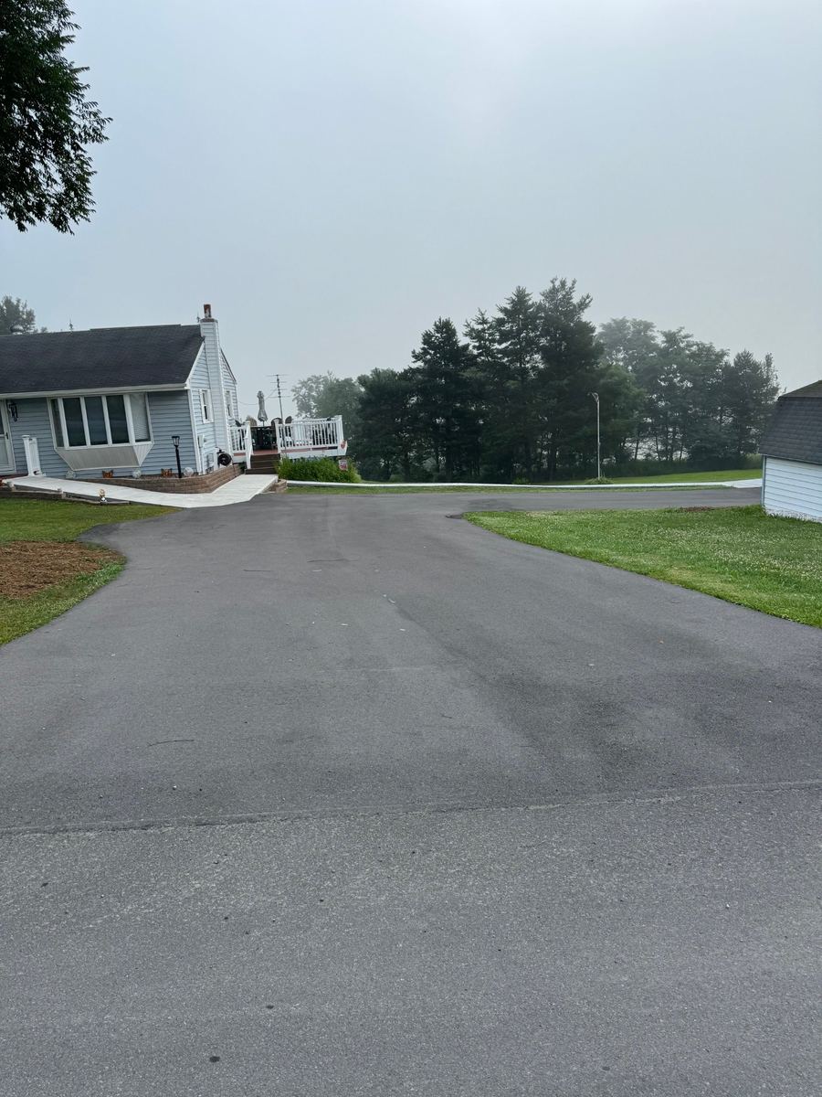 Before sealcoating – worn residential driveway with two garages