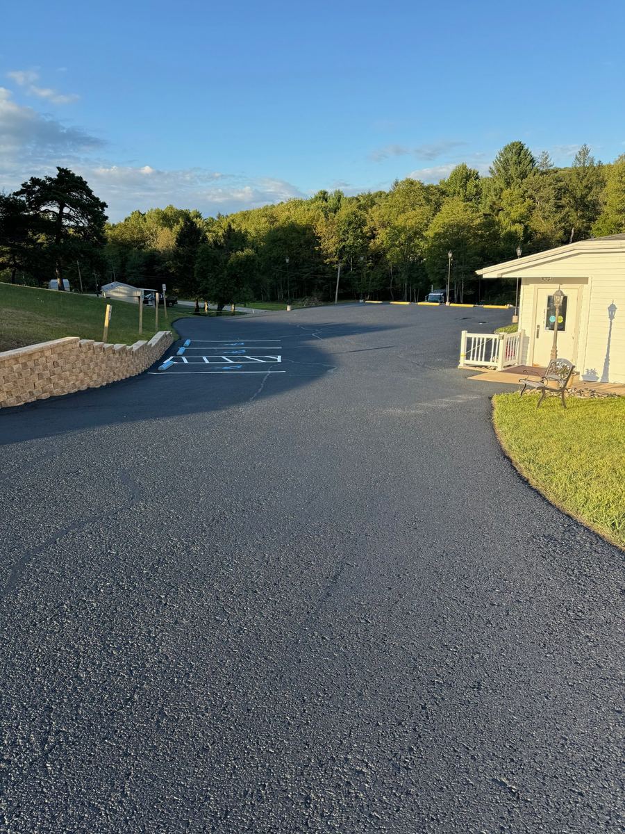 Before sealcoating – cracked and faded commercial parking lot in PA