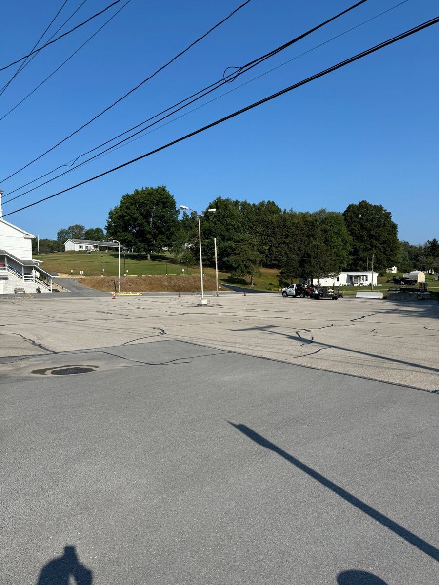 Before sealcoating – church parking lot with cracks and fading