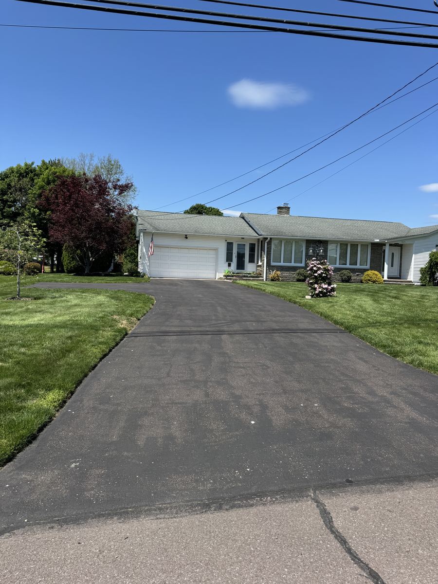 Before sealcoating – residential driveway with wear and fading